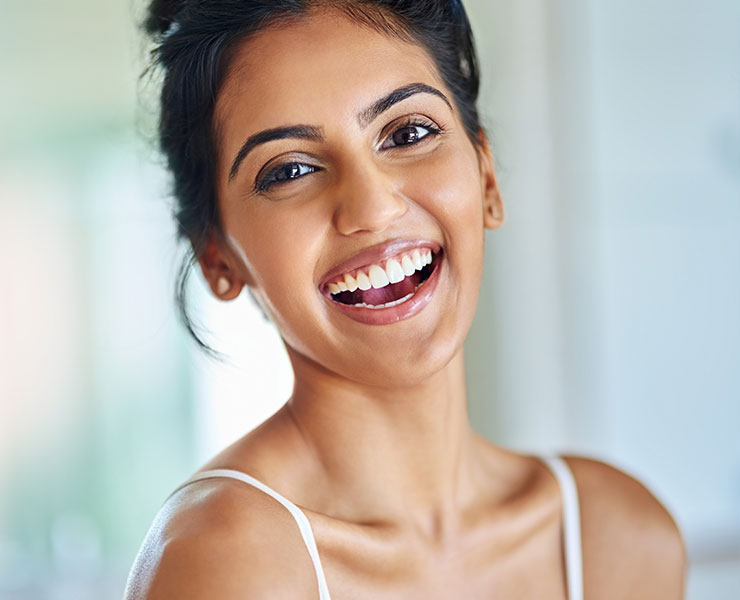 Young Indian woman smiling | Porcelain Veneers